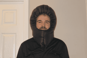 A front profile of a man wearing a down balaclava in black color.