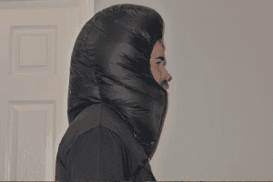 A side profile of a man wearing a down balaclava in black color.