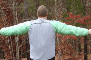 A back view of a man wearing custom cuben fiber down arm sleeves.