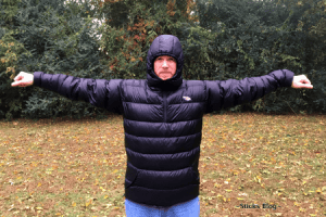 A man stands facing the camera displaying the front of his black custom down Goosefeet Anorak jacket