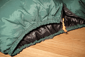 A detail image of the stitching and cinch bottom of a custom Goosefeet Gear down jacket.
