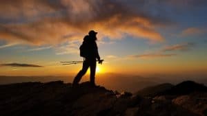 The header Image for GooseFeet Gear showing a black silhouette of a backpacker with a bright orange sunset behind them.